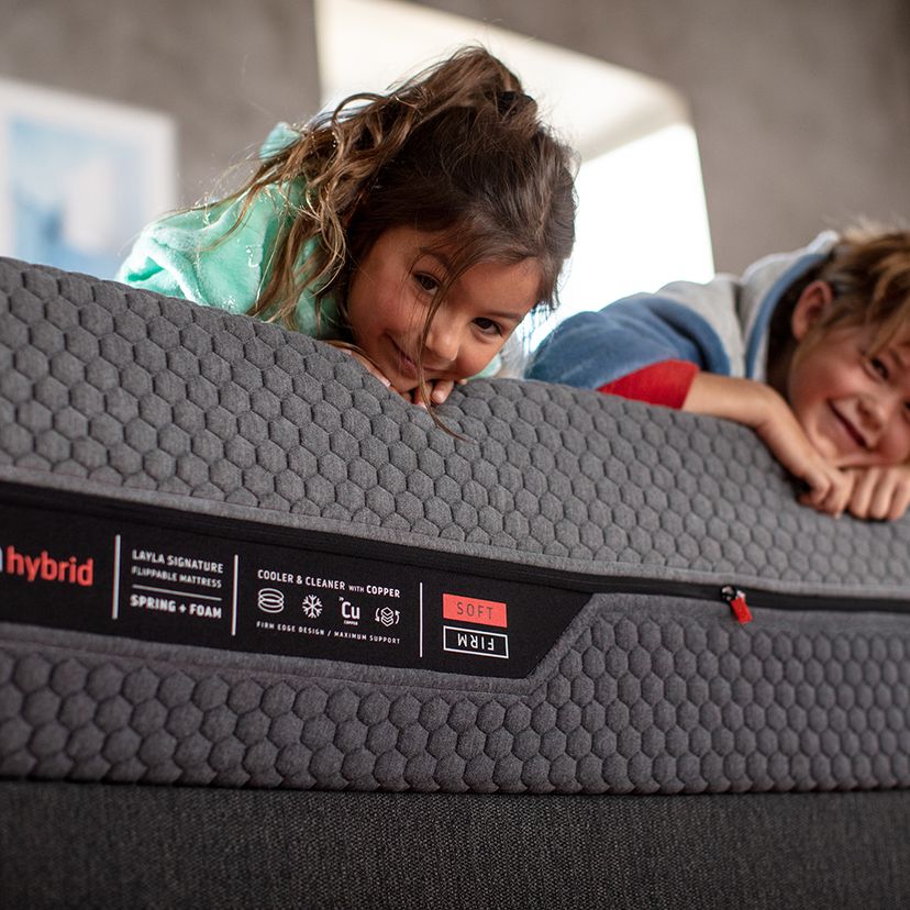 Baby Girl and her baby brother lying on Layla Hybrid Mattress