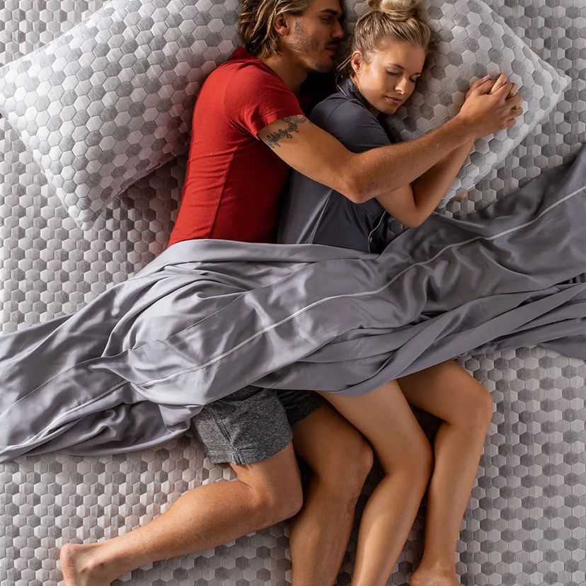 Couple laying on mattress