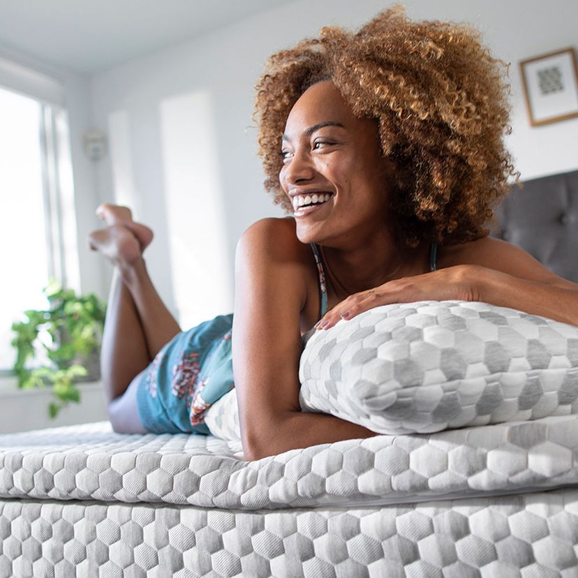 Woman laying on mattress topper