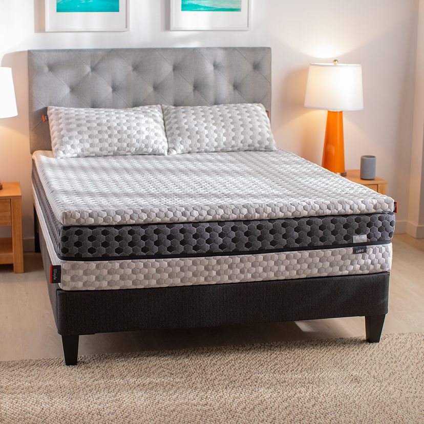 beautiful bed maked with topper