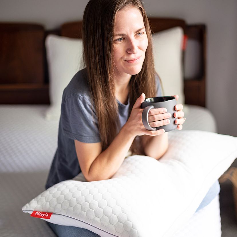 woman enjoying coffee with pillow